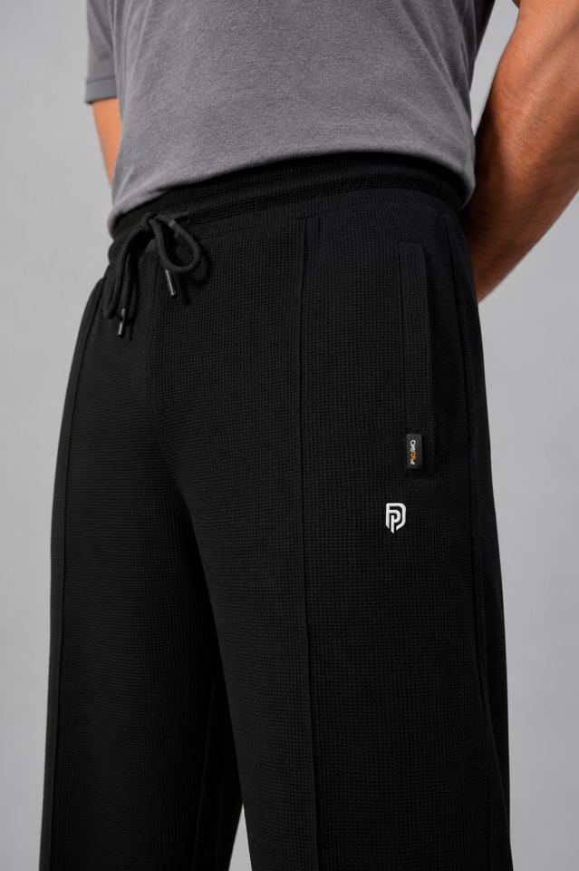 Black waffle knit trouser, close-up of drawcord waist and pintuck crease